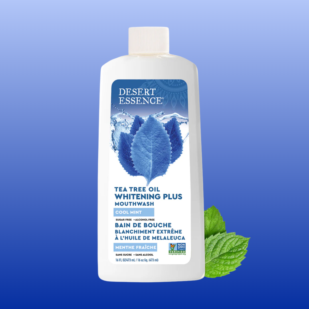 Bottle of Desert Essence Tea Tree Oil Whitening Plus Mouthwash on a blue background