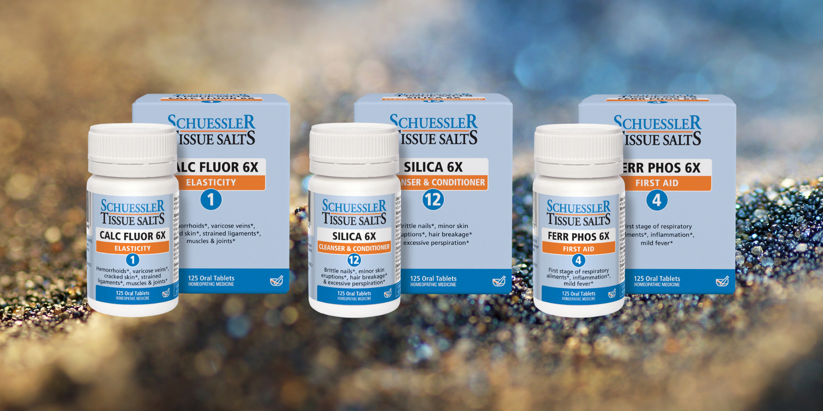 Bottles of Schuessler brand homeopathic cell salts arranged on a natural mineral surface