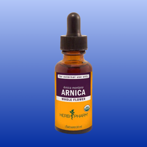 Herb Pharm Arnica montana whole flower tincture 1 oz bottle for external topical skin relief on blue background