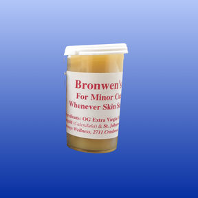 Bronwen's Healing Salve in small container with white lid, herbal balm for minor cuts and skin soothing.