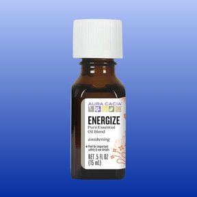 Amber glass bottle of Aura Cacia Energize essential oil blend with white cap on a blue background