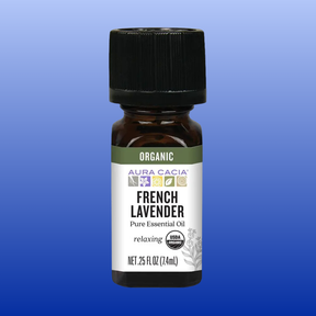 Bottle of Aura Cacia Organic French Lavender pure essential oil 0.25 oz with black cap on blue gradient background
