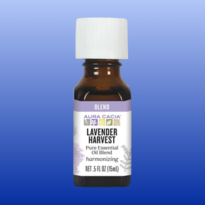 Aura Cacia Lavender Harvest 0.5 oz essential oil blend bottle with lavender and herbal label on blue background