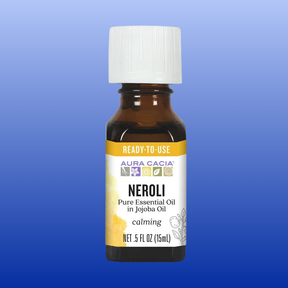 Bottle of Aura Cacia Neroli pure essential oil in jojoba oil for calming aromatherapy, 0.5 fl oz with white cap and yellow label