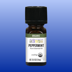 Aura Cacia Peppermint Organic Essential Oil 0.25 oz bottle with cooling effect and USDA organic seal on blue background
