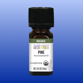 Bottle of Aura Cacia organic pine pure essential oil 0.25 oz with USDA organic label on blue background