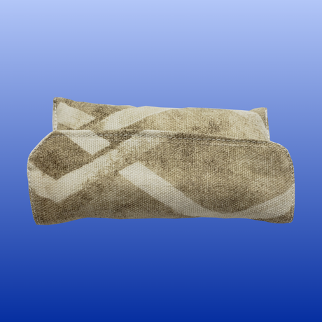 Brown and beige patterned fabric travel pouch kit folded on a blue gradient background