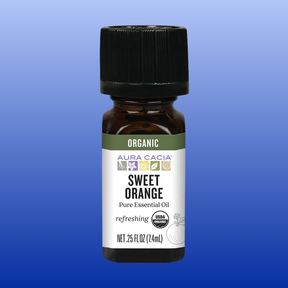 Small amber bottle of Aura Cacia Sweet Orange Organic Essential Oil 0.25 oz with black cap on gradient blue background