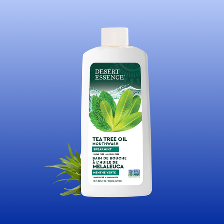 Desert Essence Tea Tree Oil Mouthwash bottle on a blue background