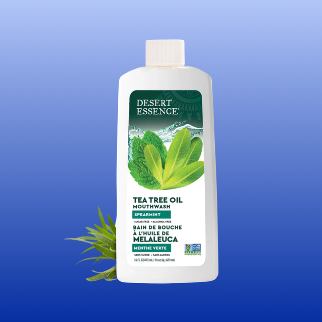 Desert Essence Tea Tree Oil Mouthwash bottle on a blue background