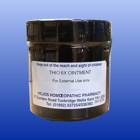 Thiosinaminum 6X ointment jar for external use, homeopathic scar reduction cream in dark container with label