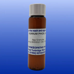 Brown bottle of Ferrum Phos 6X lactose-free cell salt granules with white cap on blue background