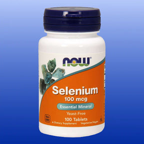 Bottle of Now brand Selenium 100 mcg essential mineral supplement with 100 yeast-free tablets on blue background
